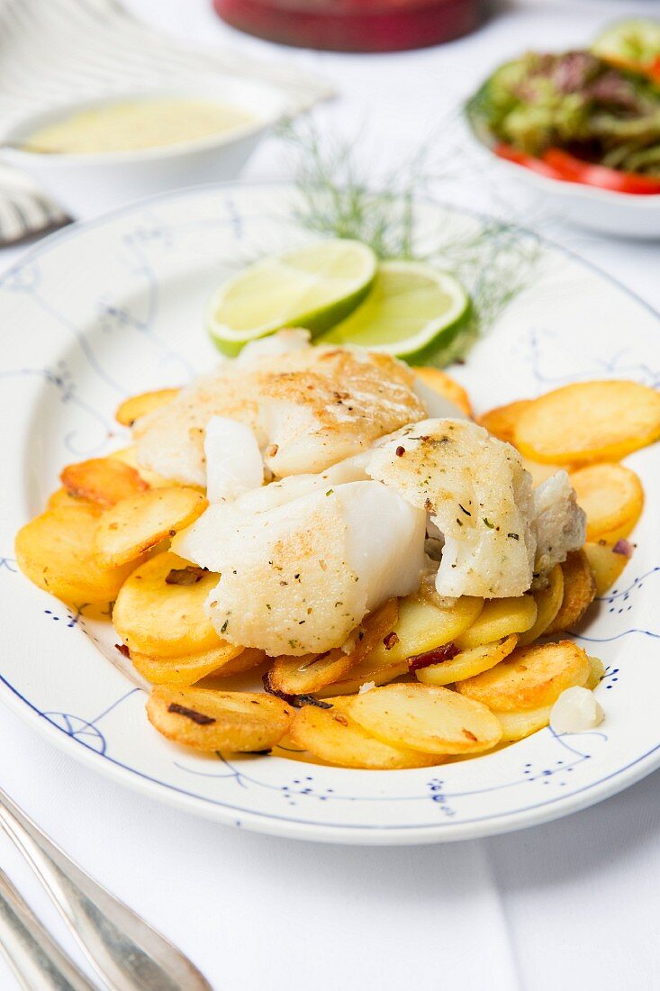 Fried fish with fried potatoes and mushroom sauce