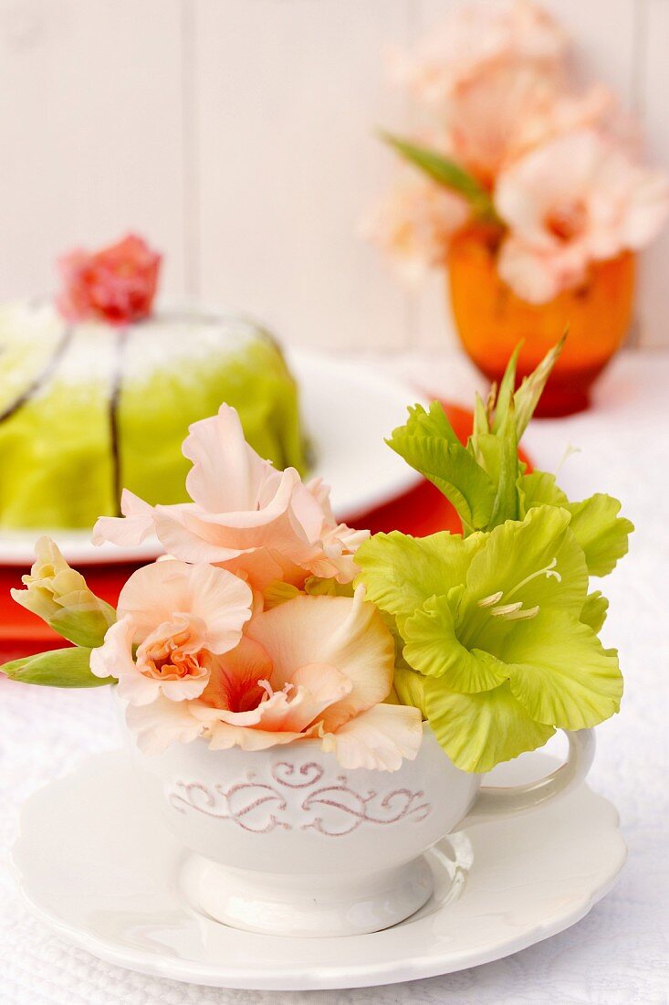 Arrangement of gladiola florets in teacups