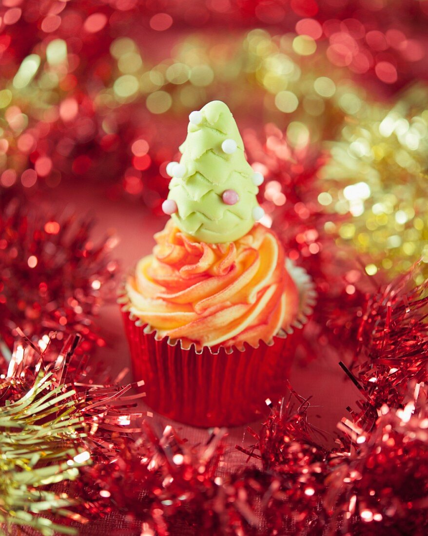 A Christmas cupcake decorated with a fondant tree