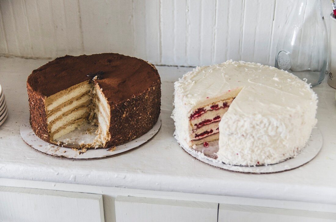 Two layered cakes on a dresser