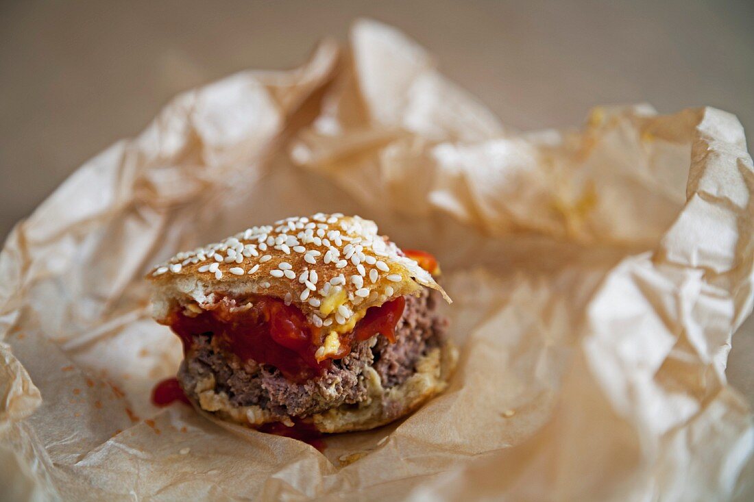 The remains of a hamburger on a piece of paper