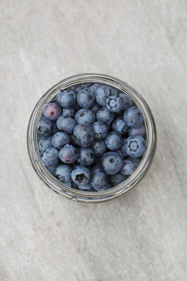Fresh blueberries in a jar (seen from above)