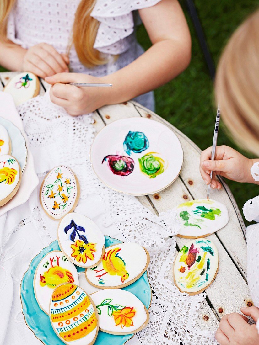 Girls paint Easter cookies