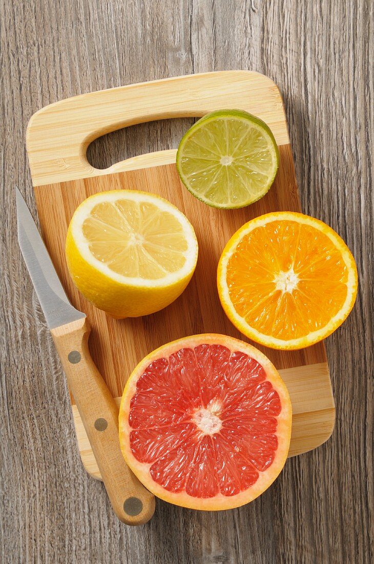Juicy citrus fruits on a wooden chopping board
