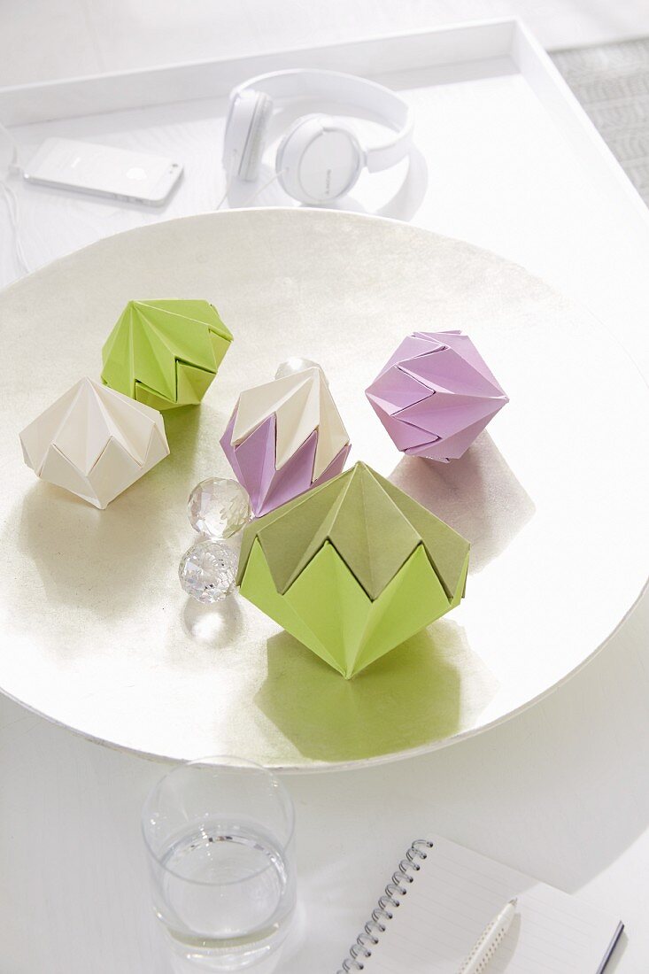 Homemade decorative diamonds made from stiff, coloured paper