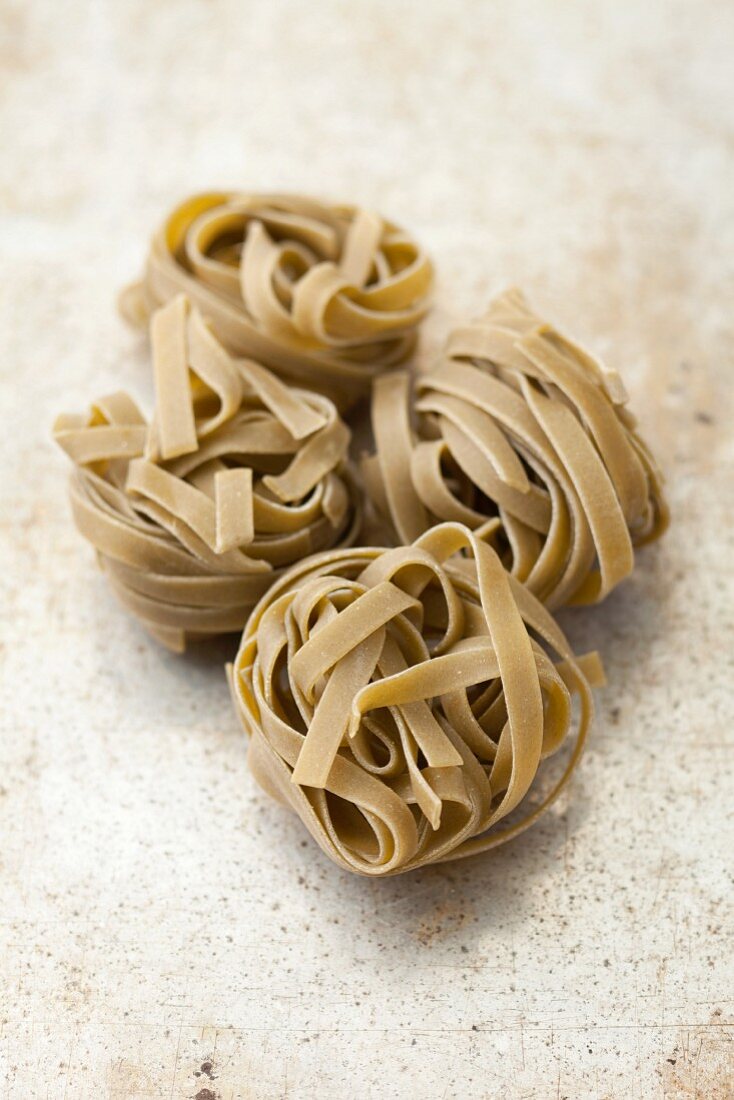 Spinach tagliatelle on a grey surface