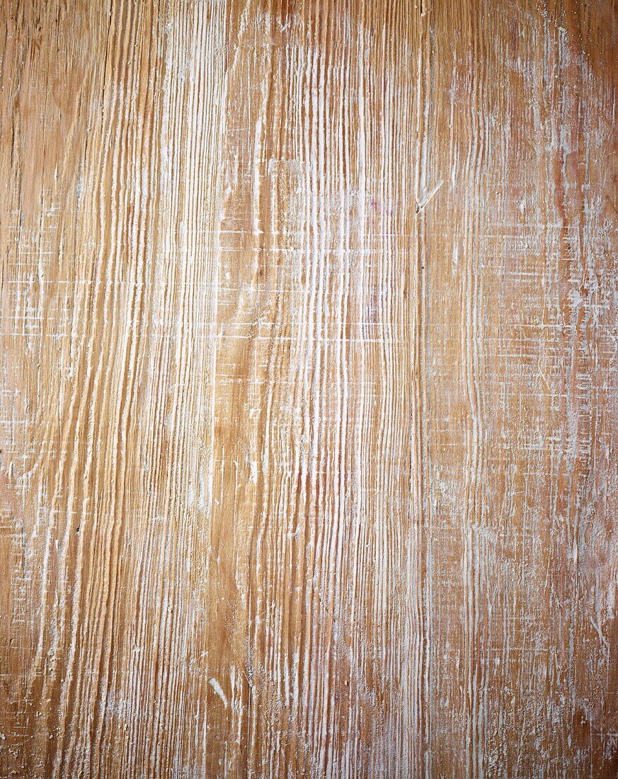 A floured wooden work surface (seen from above)