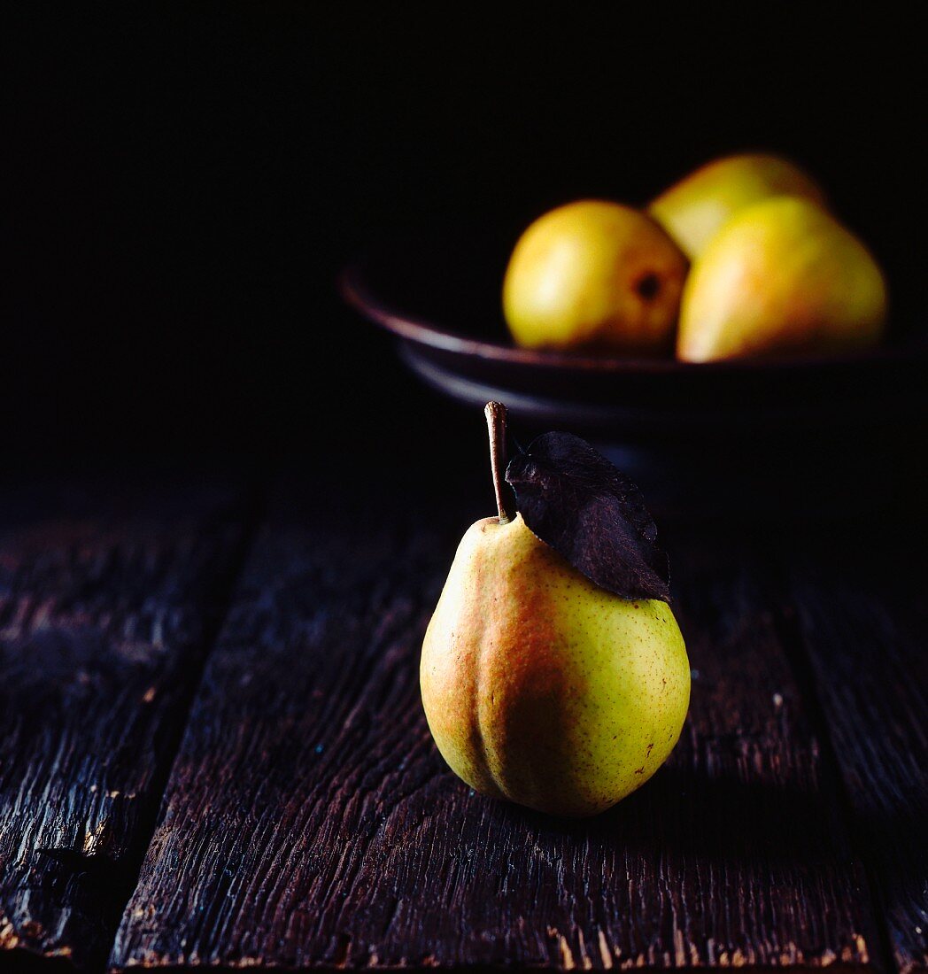 Fresh pears on a black surface