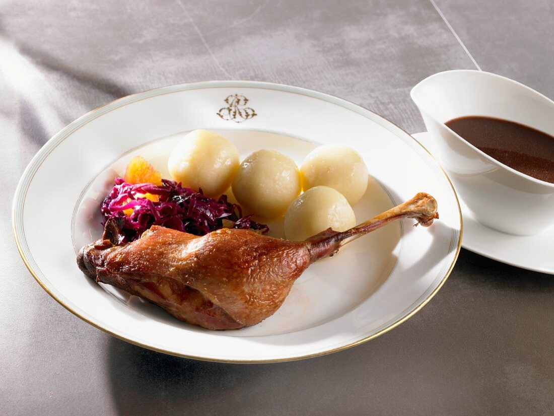 Goose leg with red cabbage, dumplings and gravy