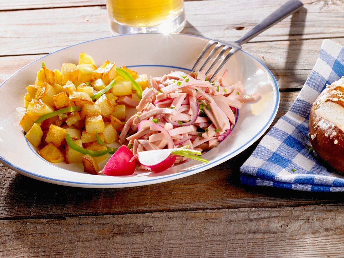 Fried potatoes with a sausage salad (Bavaria, Germany)