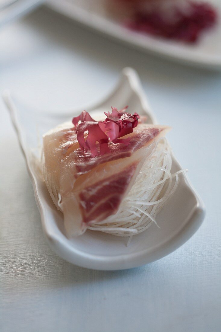 Bream sashimi on strips of radish