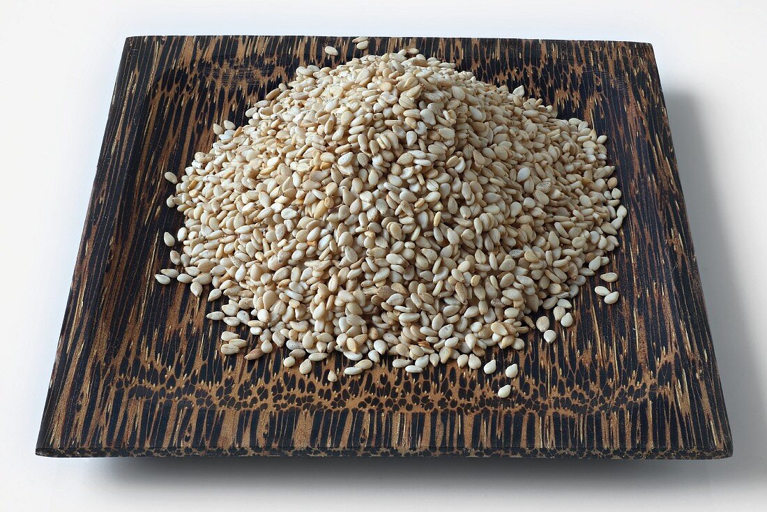 Sesame seeds on a coconut wood dish