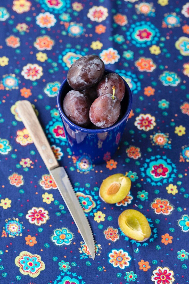 Damsons in a blue cup