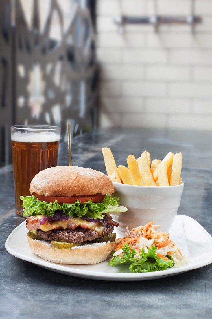 A burger with chips and beer