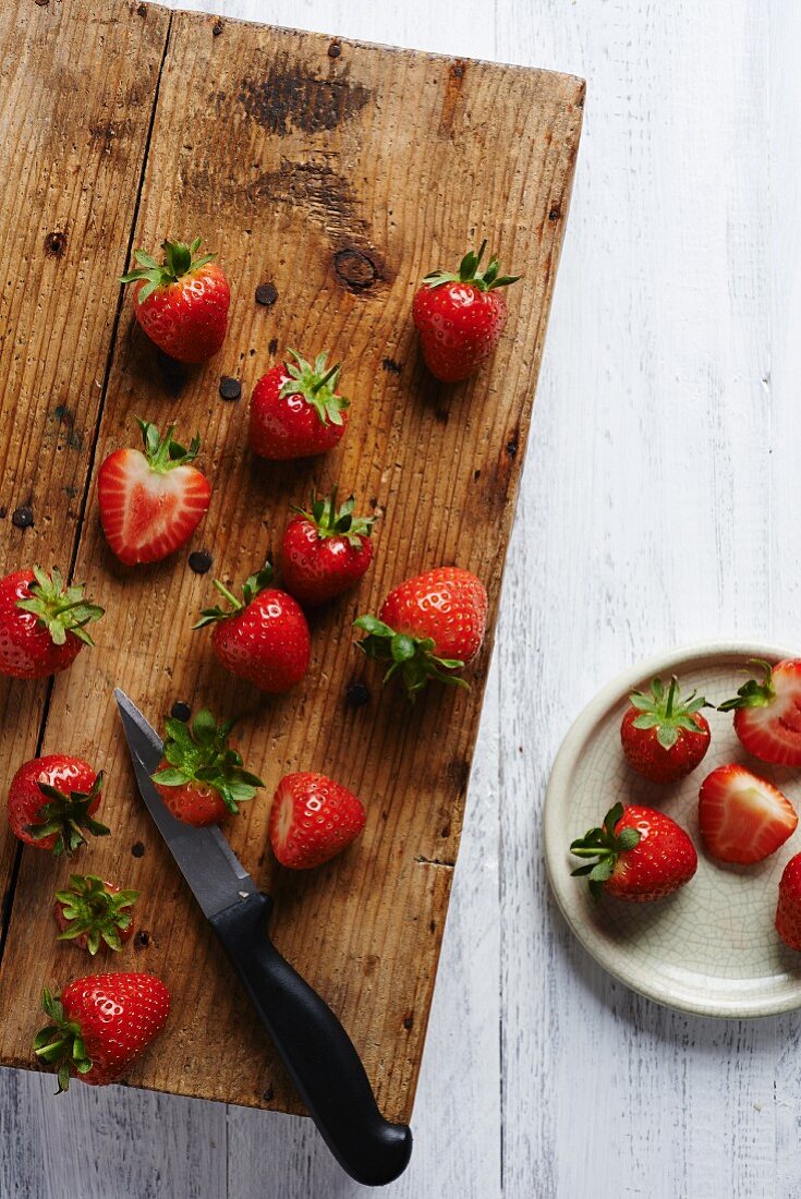Strawberries on a rustic wooden chopping board
