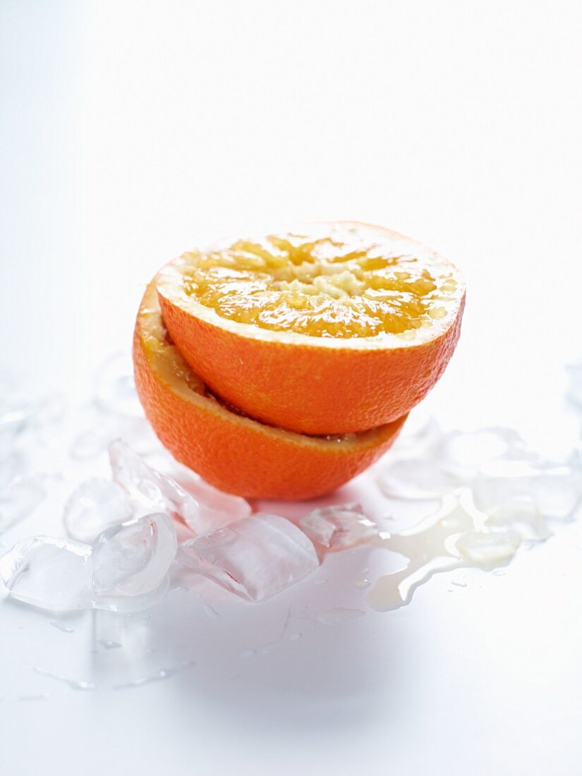 A halved orange on ice