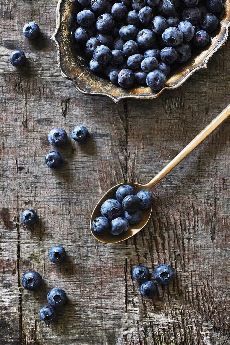 Blueberries on a silver plate and spoon