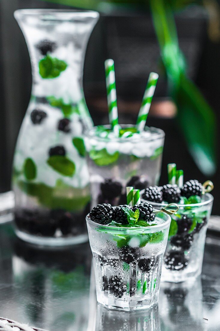 Water with blackberries, ice cubes and mint