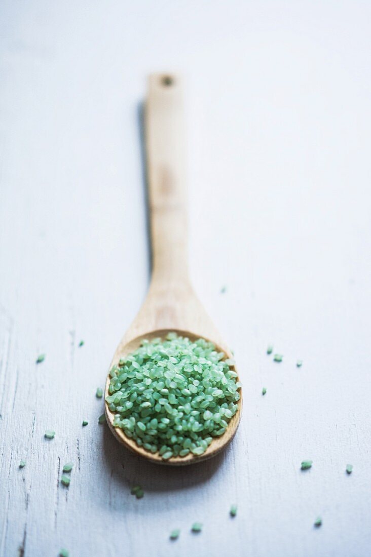 Green Japanese rice on a wooden spoon