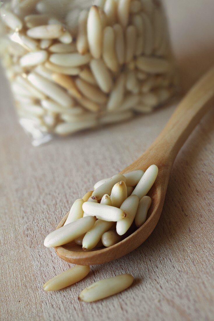 Pine nuts on a wooden spoon