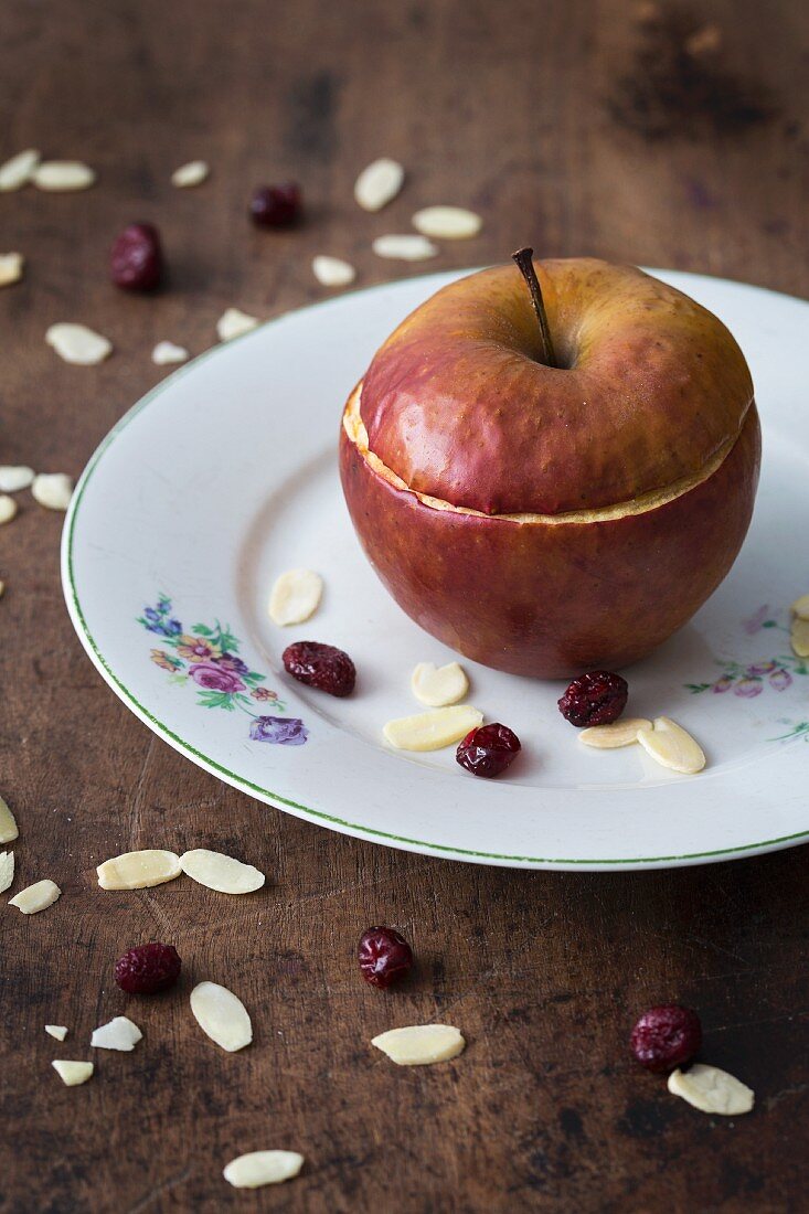 A baked apple filled with almonds and dried cranberries