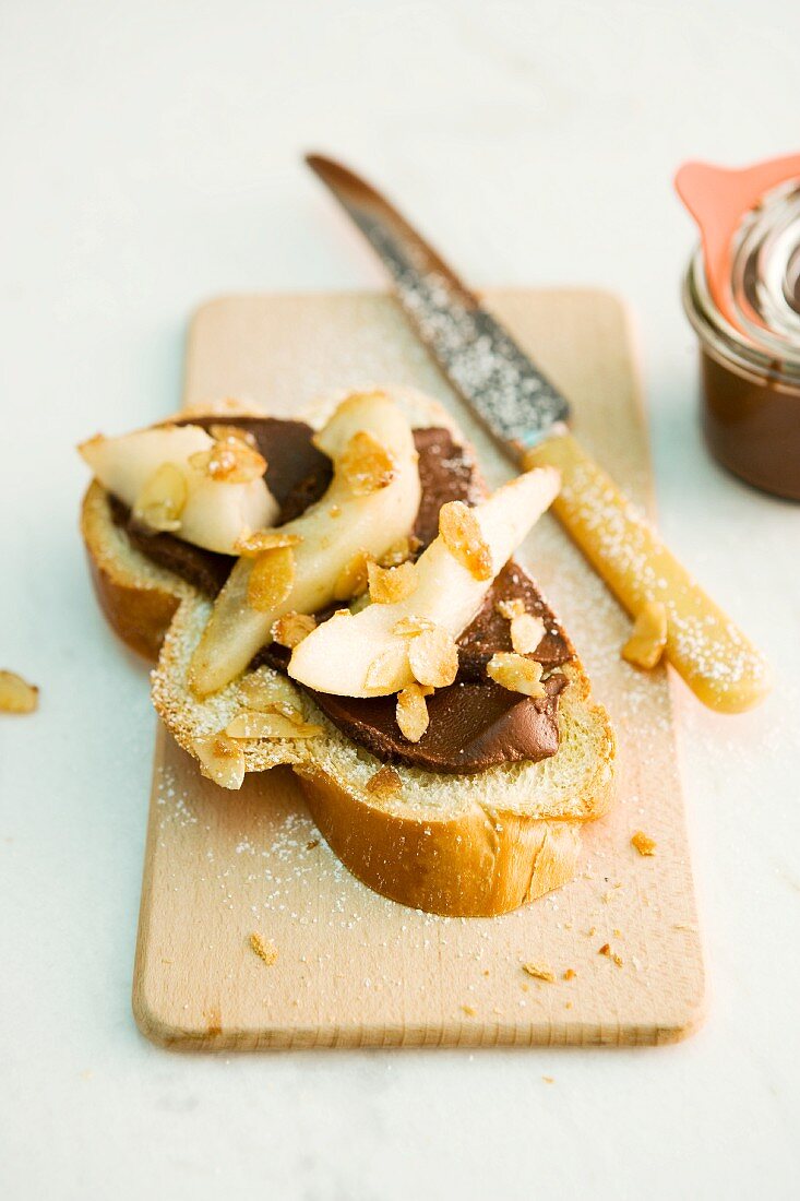 A slice of sweet yeast bread topped with chocolate cream and pears