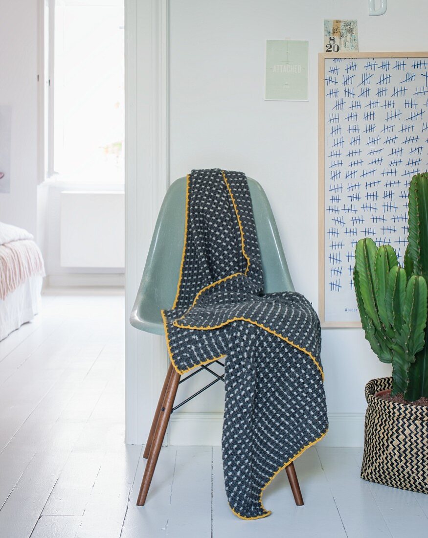 A crocheted blanket on a chair