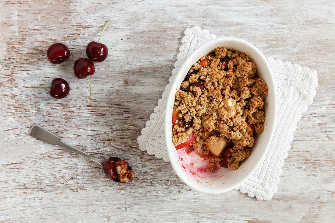 Apple and cherry crumble in a baking dish