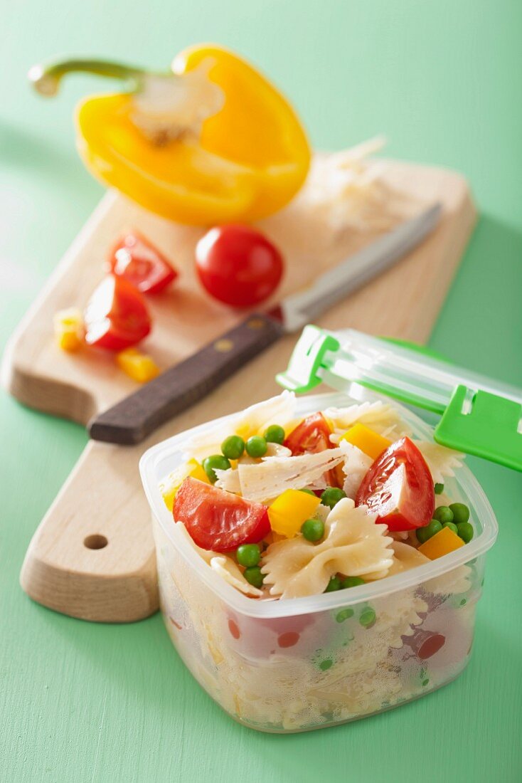 A lunch box with pasta salad and ingredients