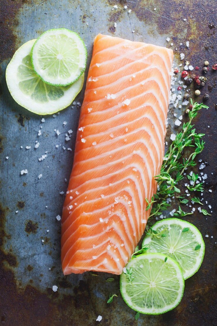 Raw salmon fillet on a metal surface