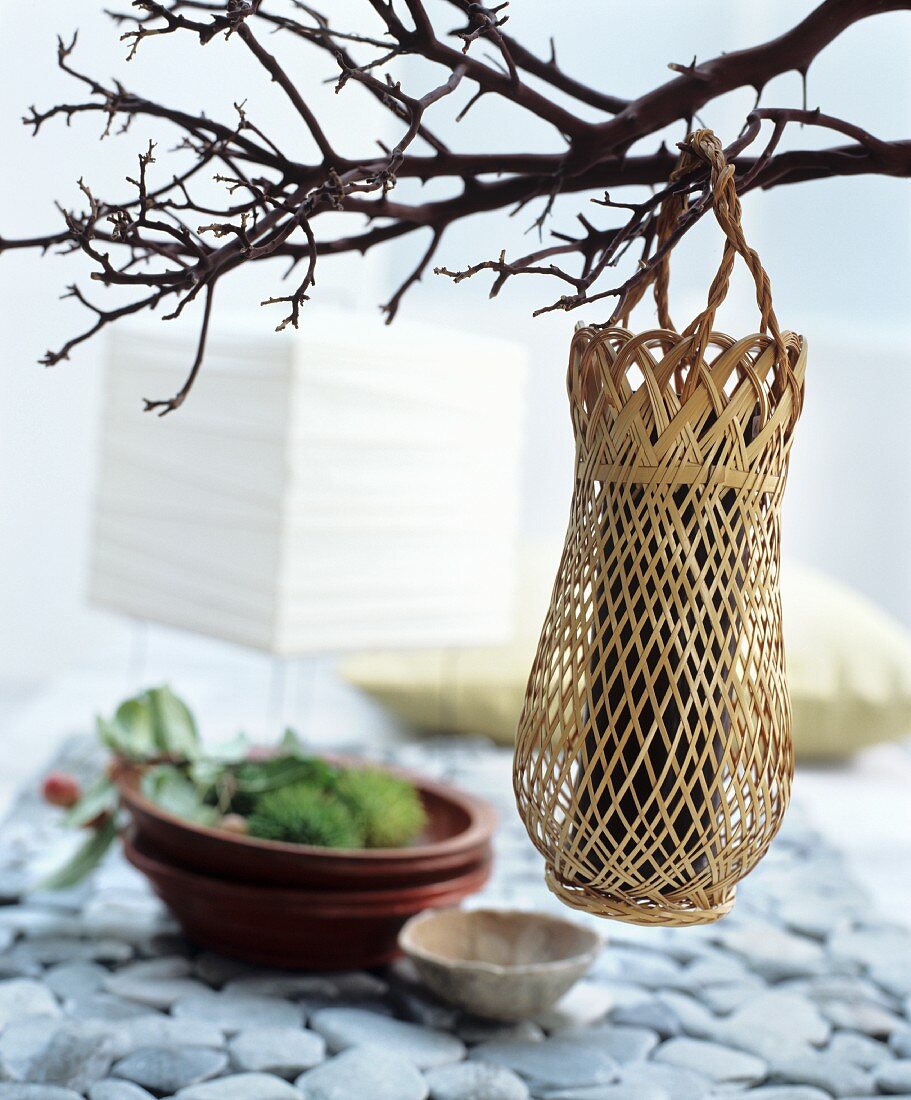 Oriental-style decoration idea: a woven vase hung on a twig