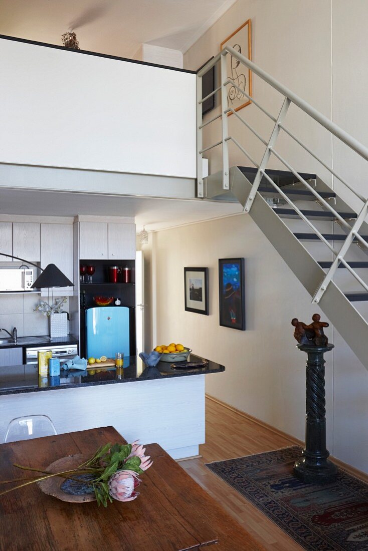 Kitchen-dining room and stairs leading to gallery in apartment