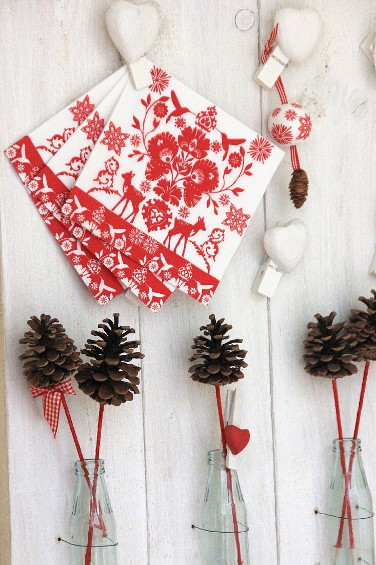 Festive arrangement of napkins, love-hearts & pine cones
