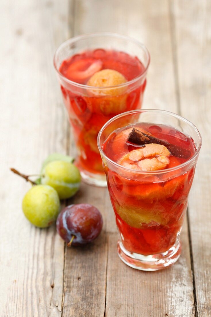 Glasses of plum compote with cinnamon