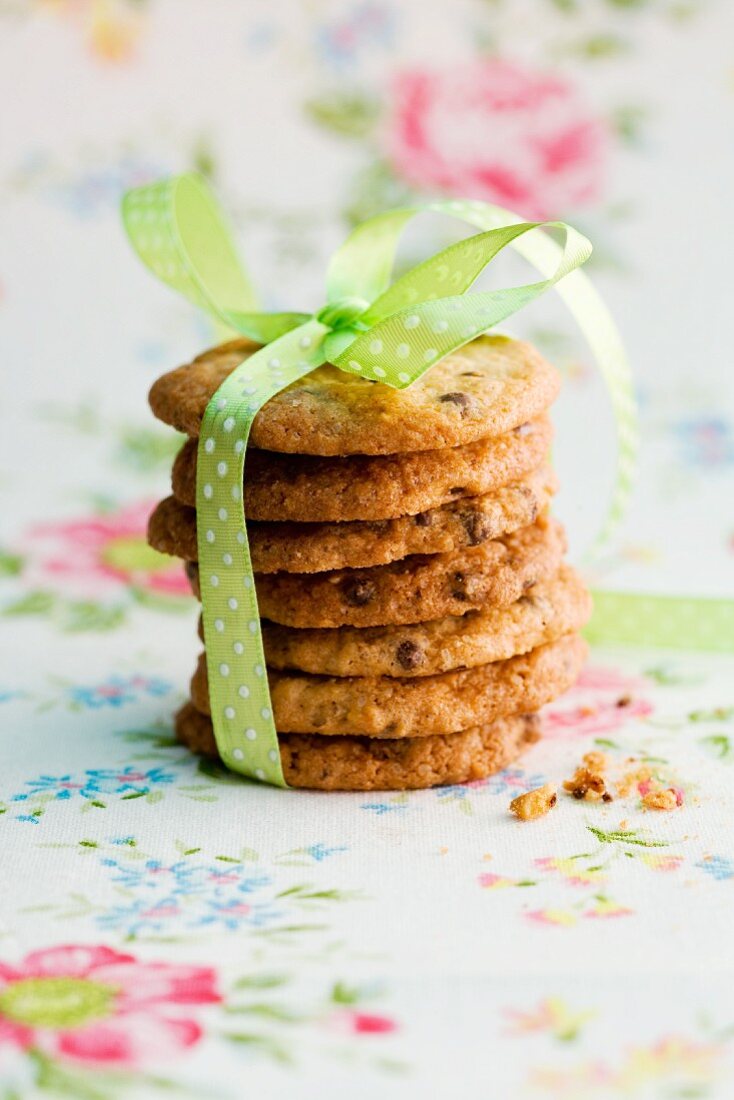A stack of chocolate chip cookies with a ribbon