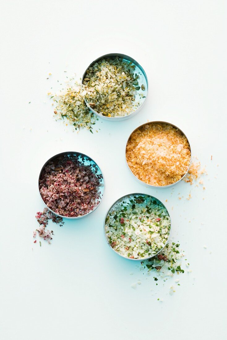 Various types of spicy salts in dishes (seen from above)
