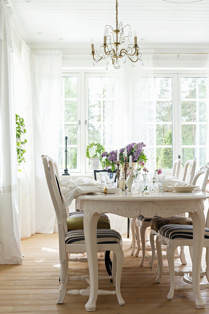 Set table in dining room with Gustavian-style furniture