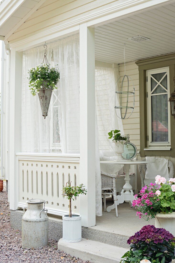 Flowers and curtains on veranda of Swedish house