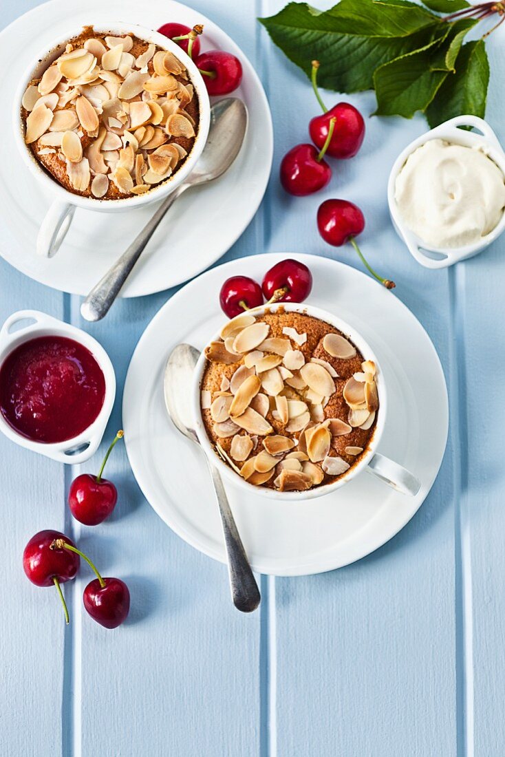 Cherry clafoutis in cups with cherry sauce (seen from above)