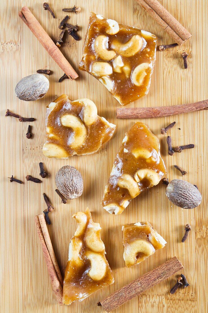 Cashew brittle with spices on a wooden surface