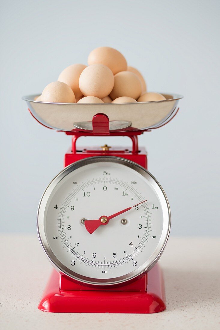 Organic eggs on pair of red vintage kitchen scales