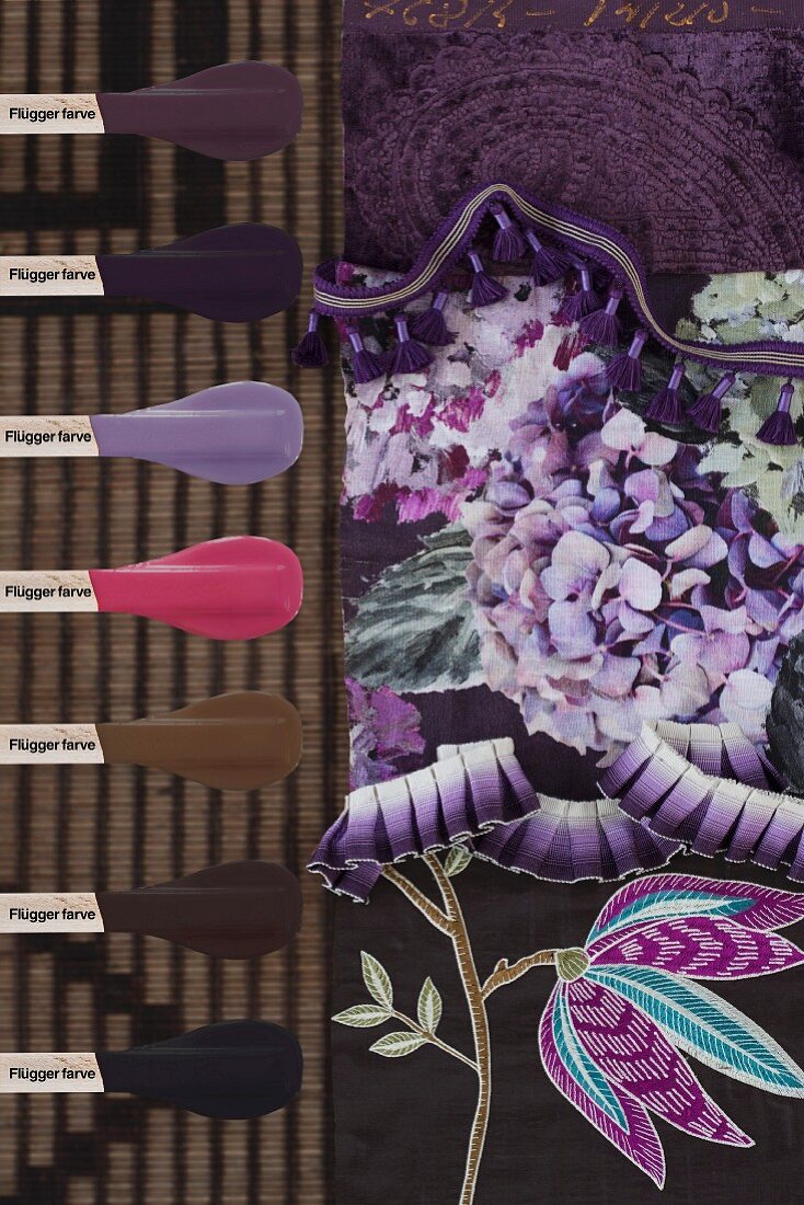 Paint samples next to fabric with purple floral pattern