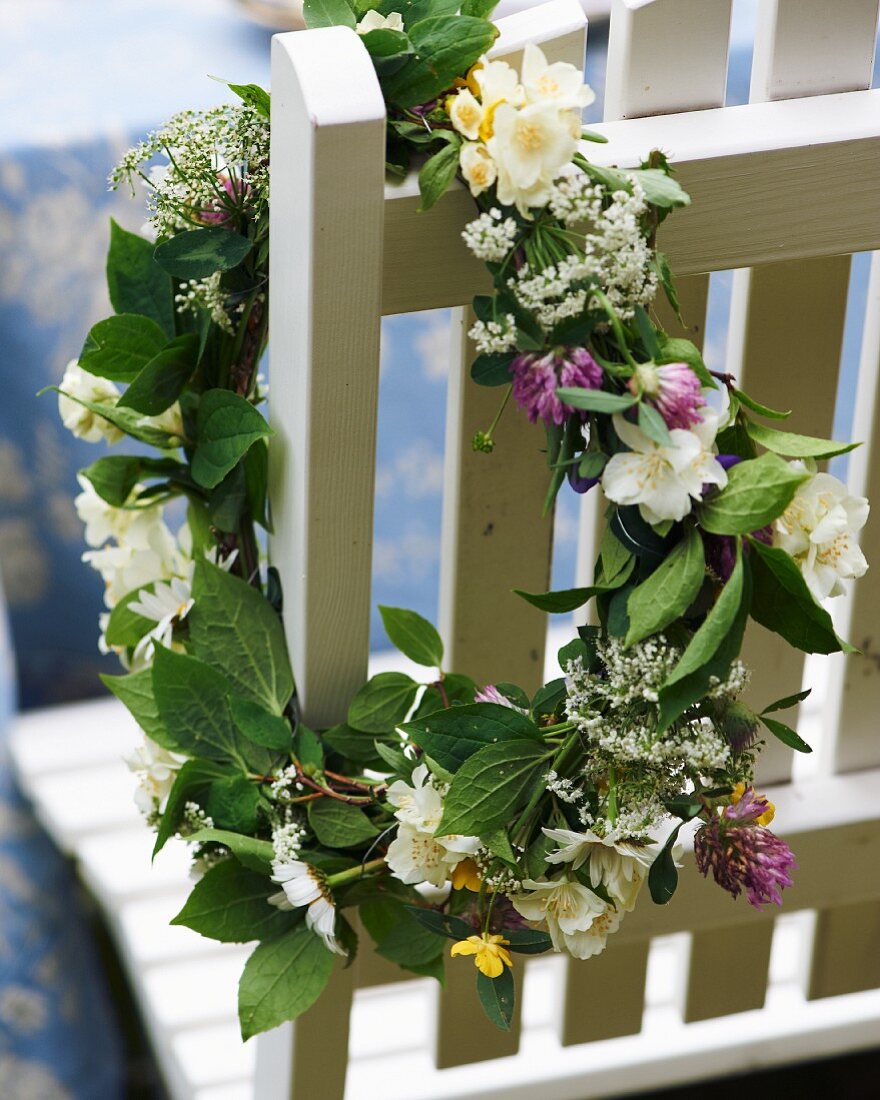 Garden chair decorated with wreath of flowers for midsummer festival