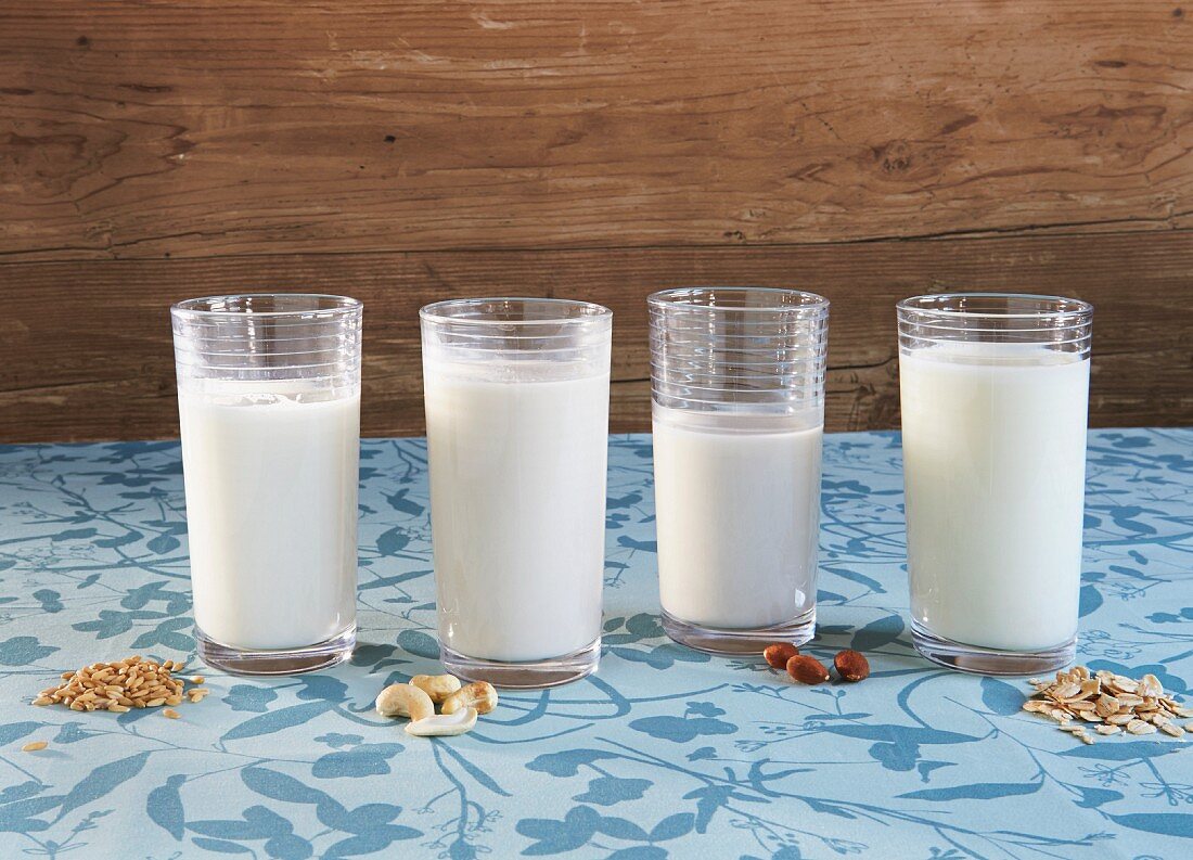 Different types of vegan milk: grain milk, cashew milk, almond milk and oat milk