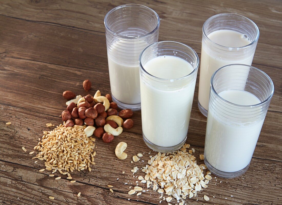 Various types of vegan milk with ingredients