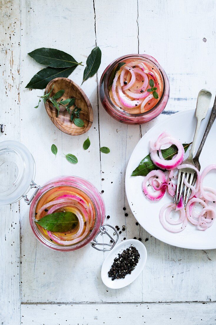 Red onions pickled in vinegar with fresh herbs and pepper