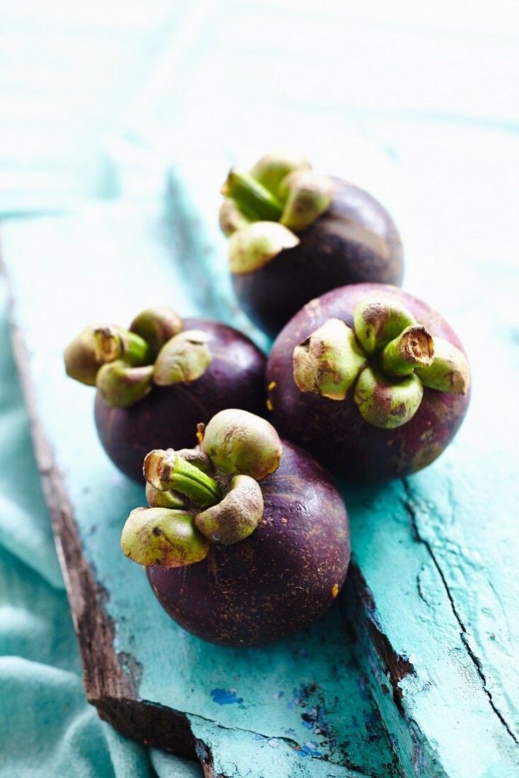 Mangosteens from Bali on blue wood