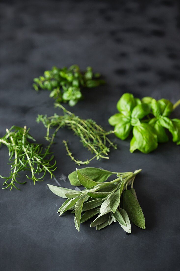 Fresh herbs on a dark surface