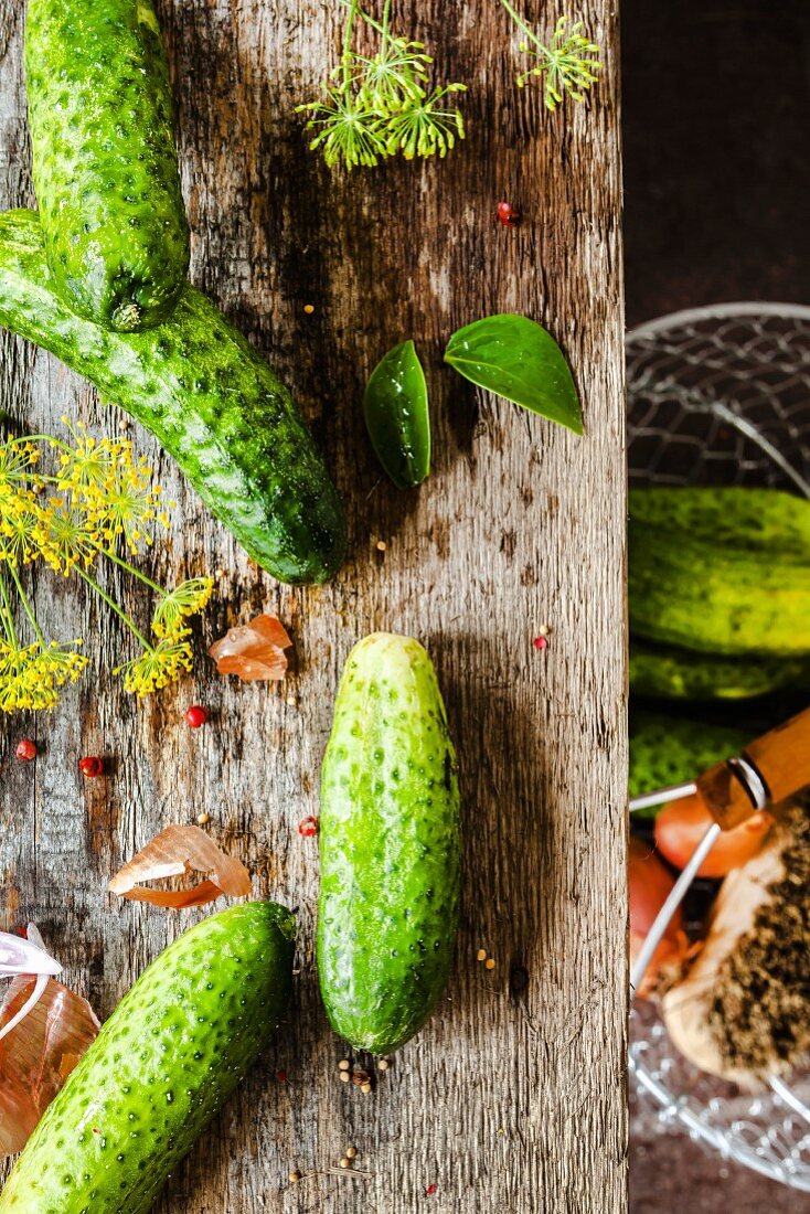 Pickling cucumber on a wooden board and in a basket