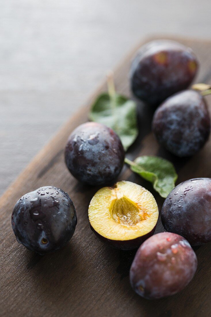 Fresh damsons on a wooden board